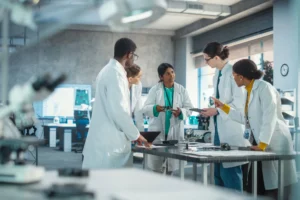 Lab team meeting at a workbench.